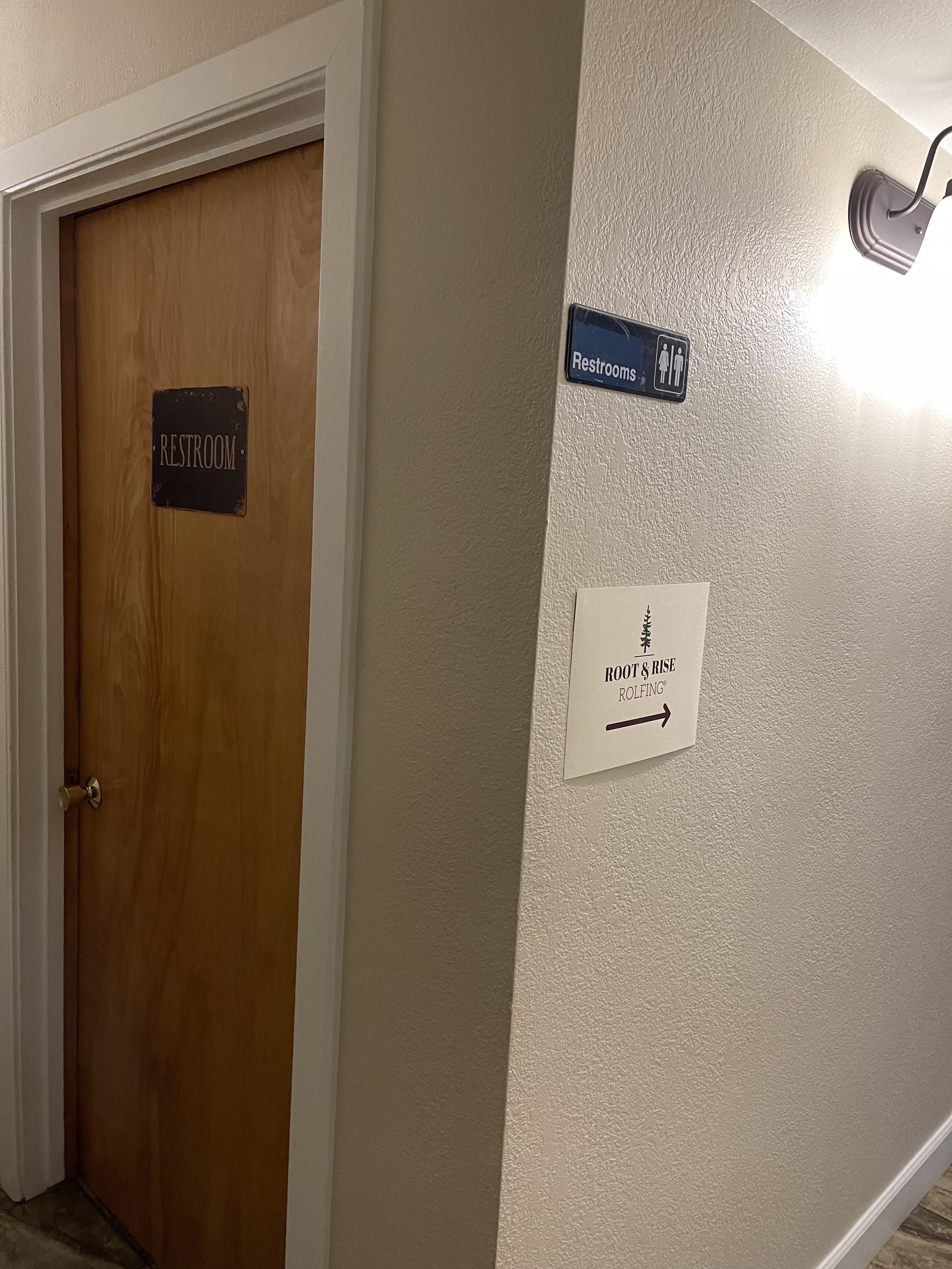 Door to restroom, improperly signed and with a round doorknob