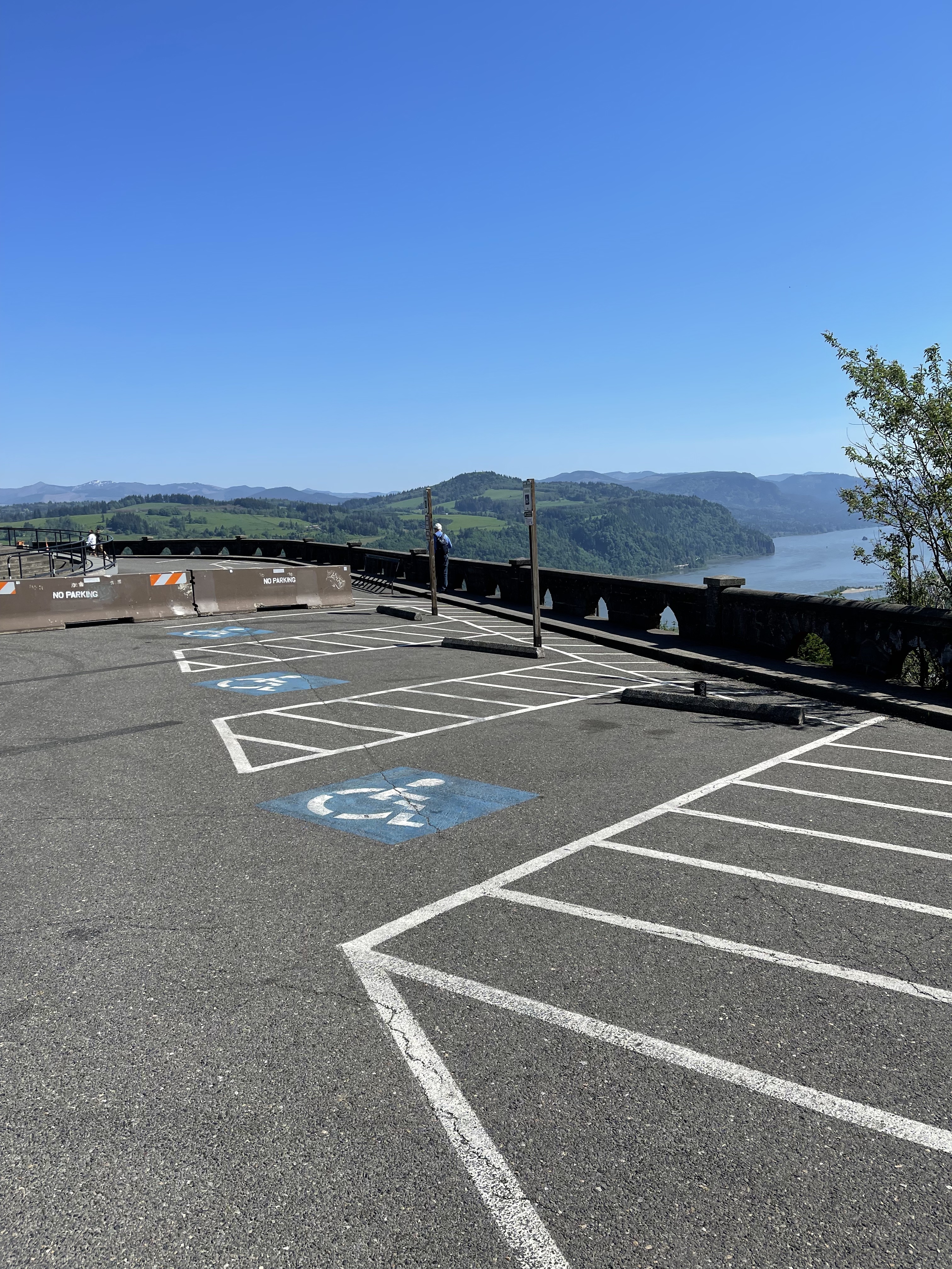 photo shows 3 accessible parking spaces with striped access aisles in between
