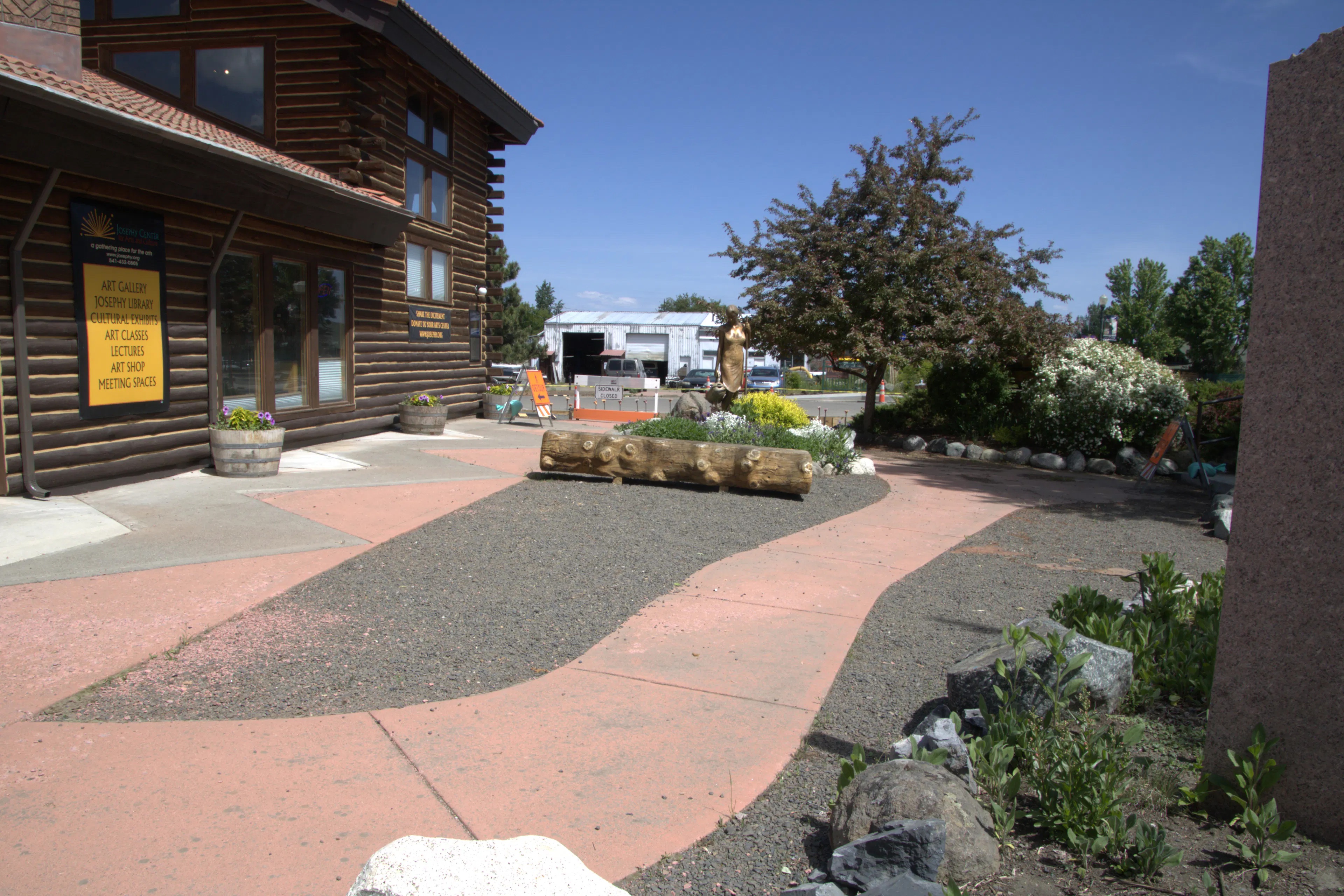 exterior of building with paved patio and outdoor art