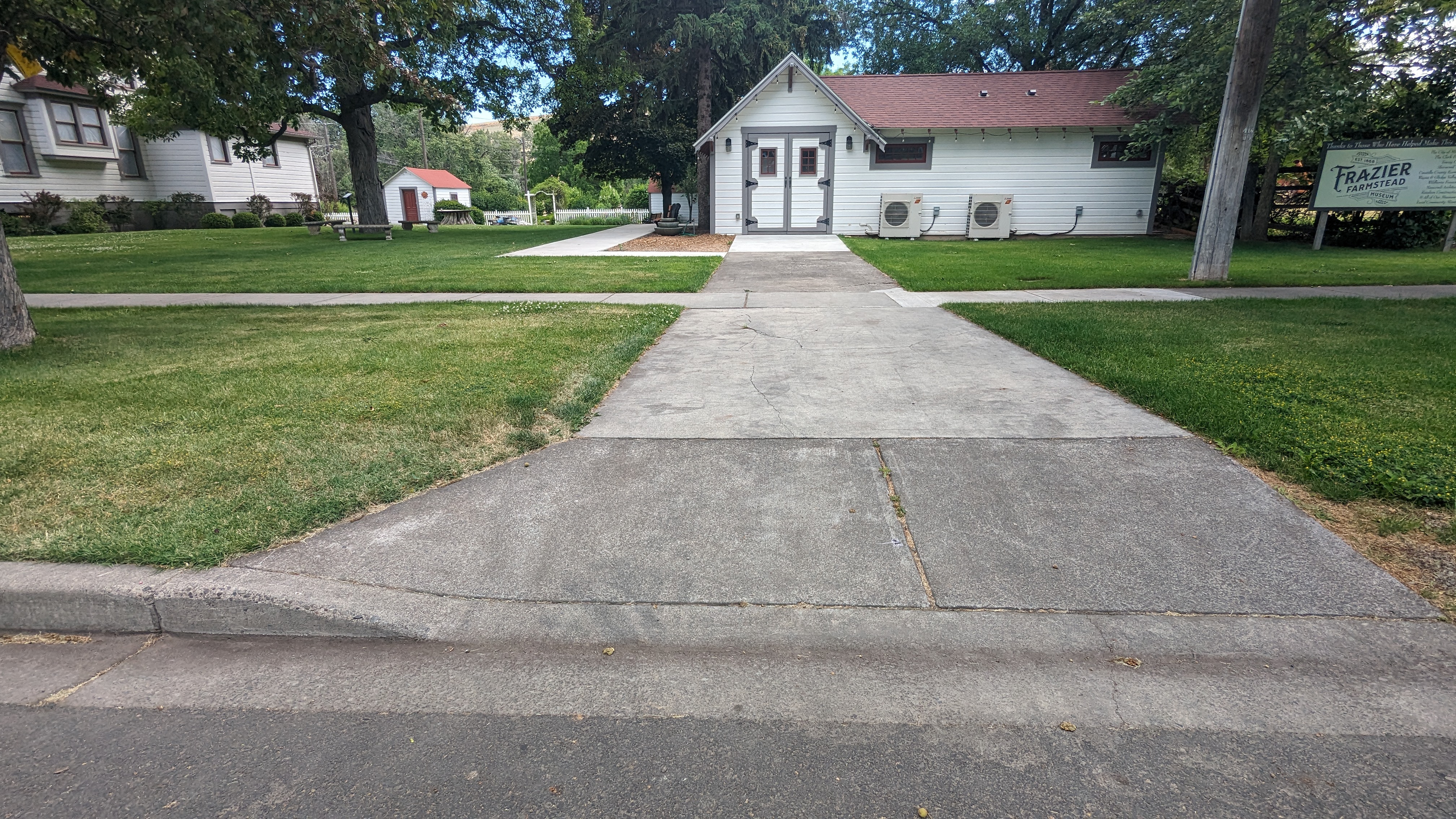 Curb cut from street parking in front of driveway. Concrete paths.
