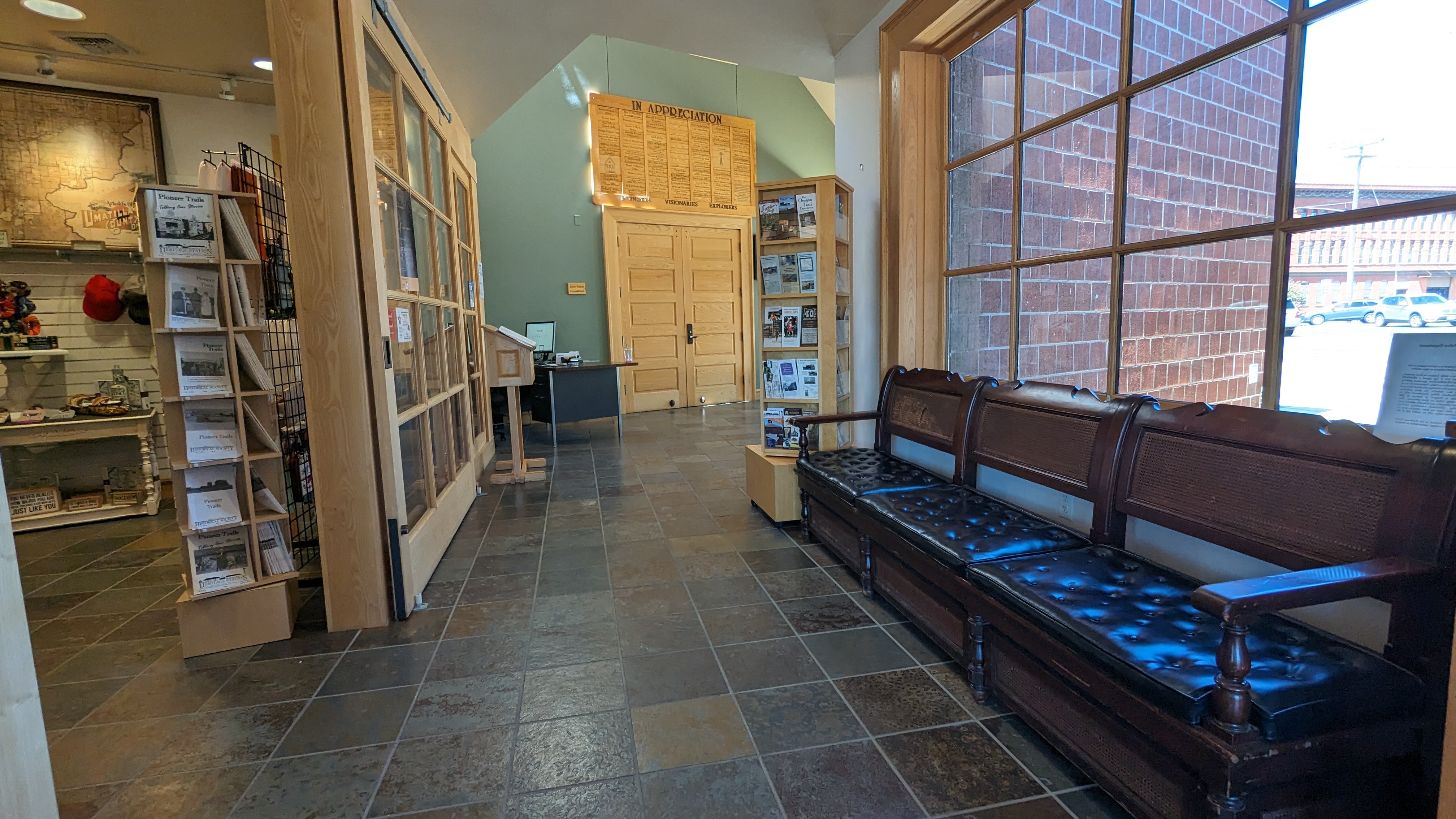 Hallway with seating next to gift shop.