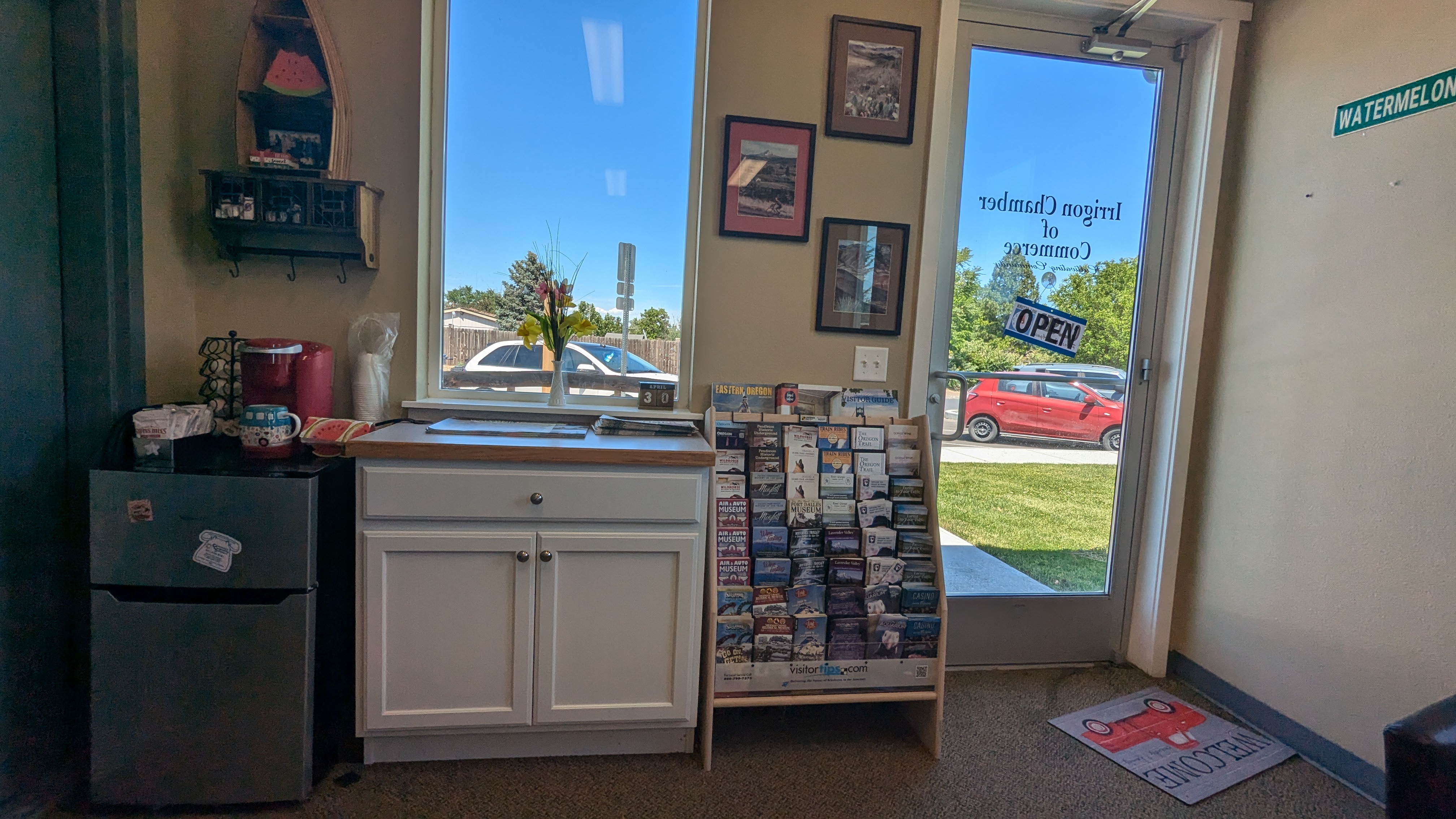 Single entrance into a small room with brochures and low desk.