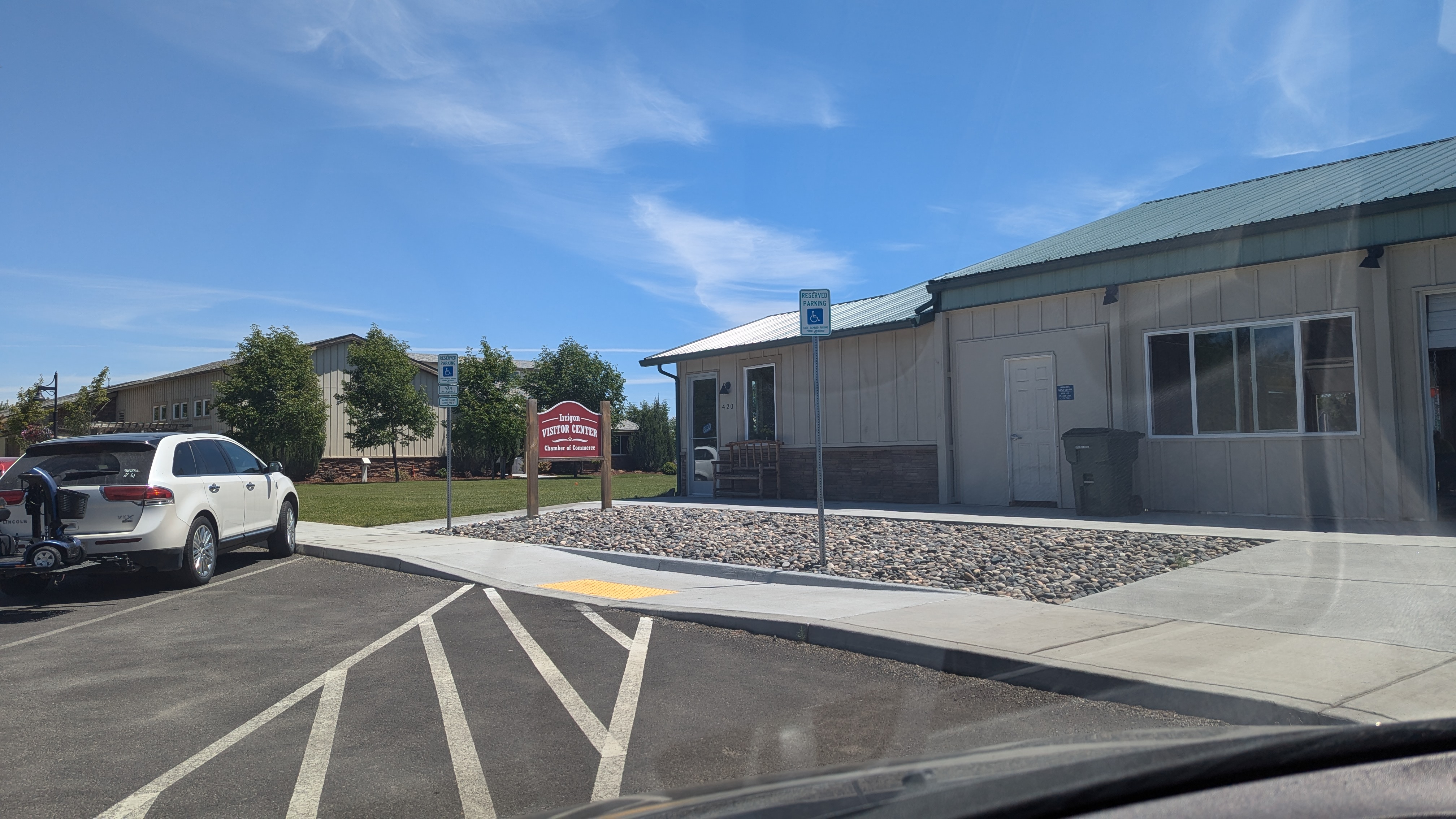 2 ADA parking spaces with center aisle in front of business.