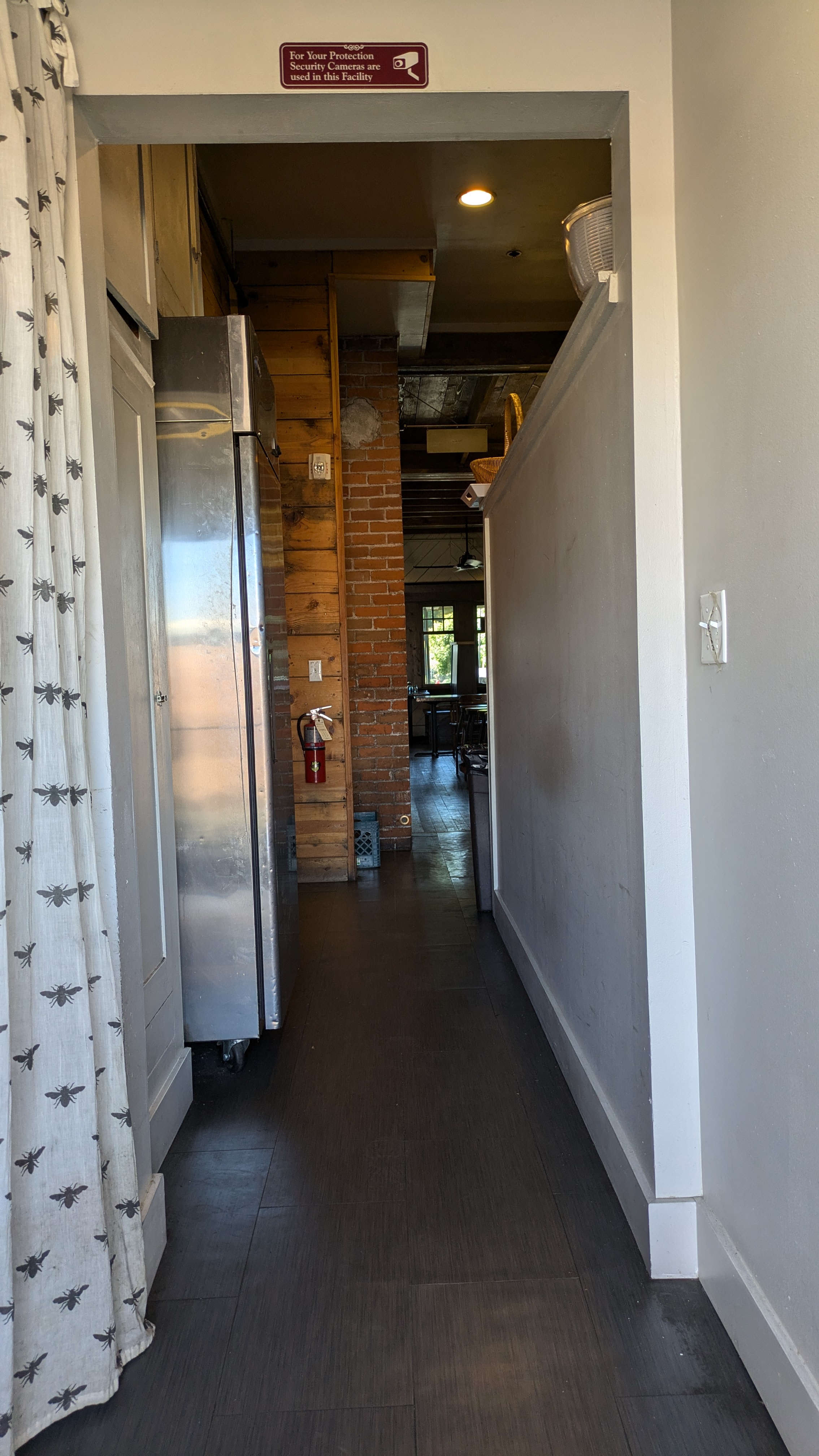 Hallway from back ramp entrance, narrows at fridge.