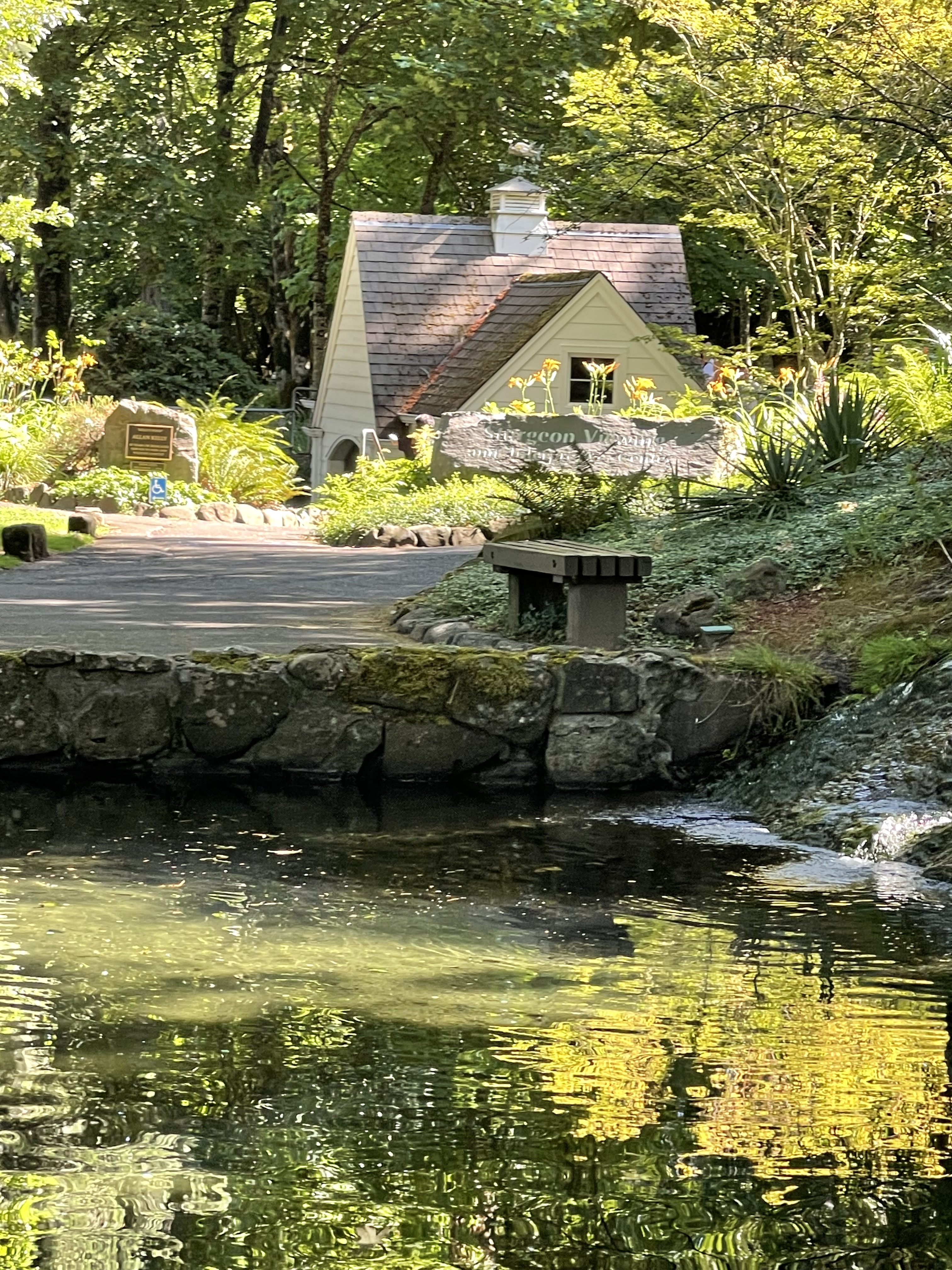 Pastoral view of older building and ponds surrounding it
