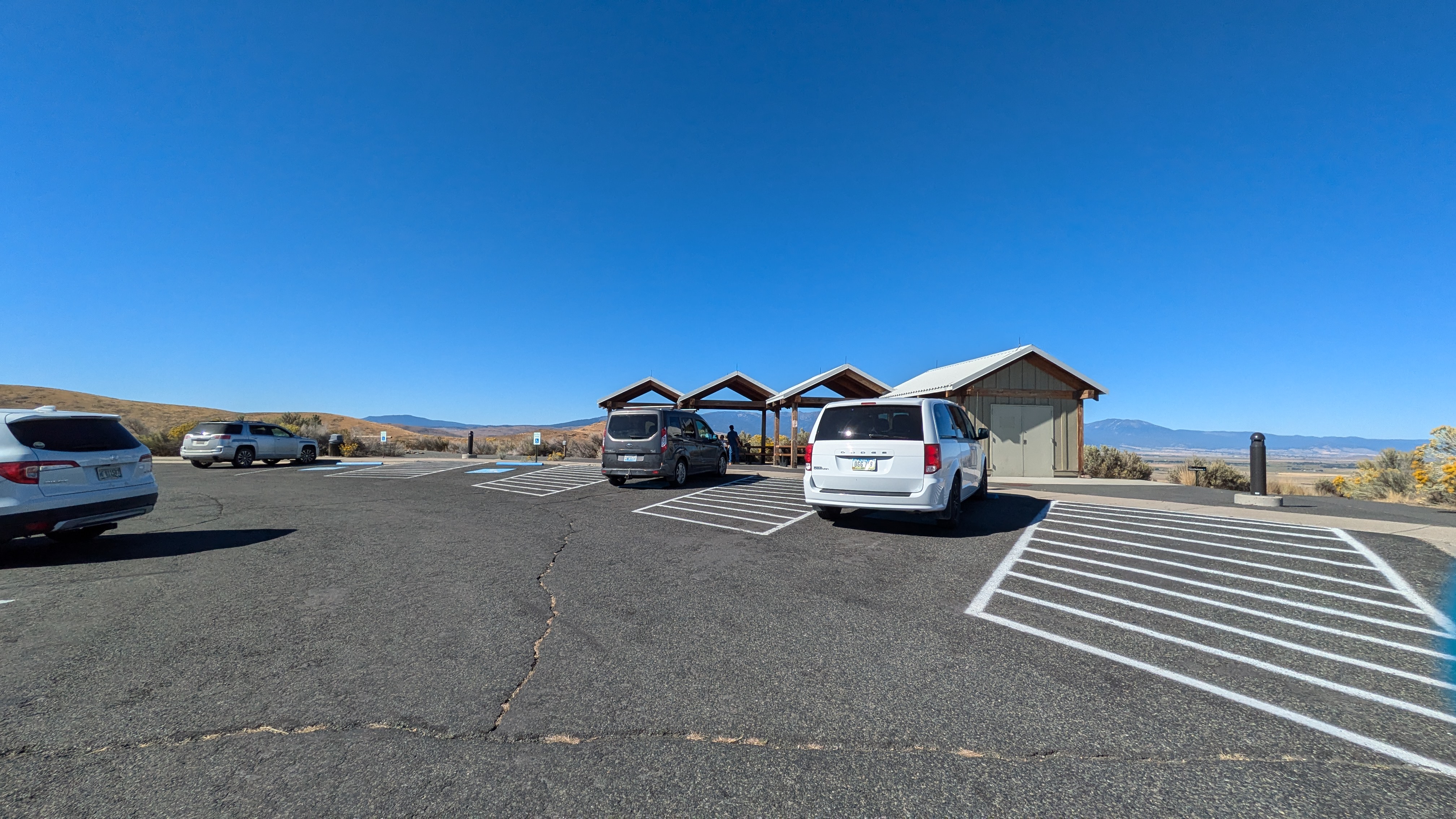 4 ADA parking spots in front of covered picnic area
