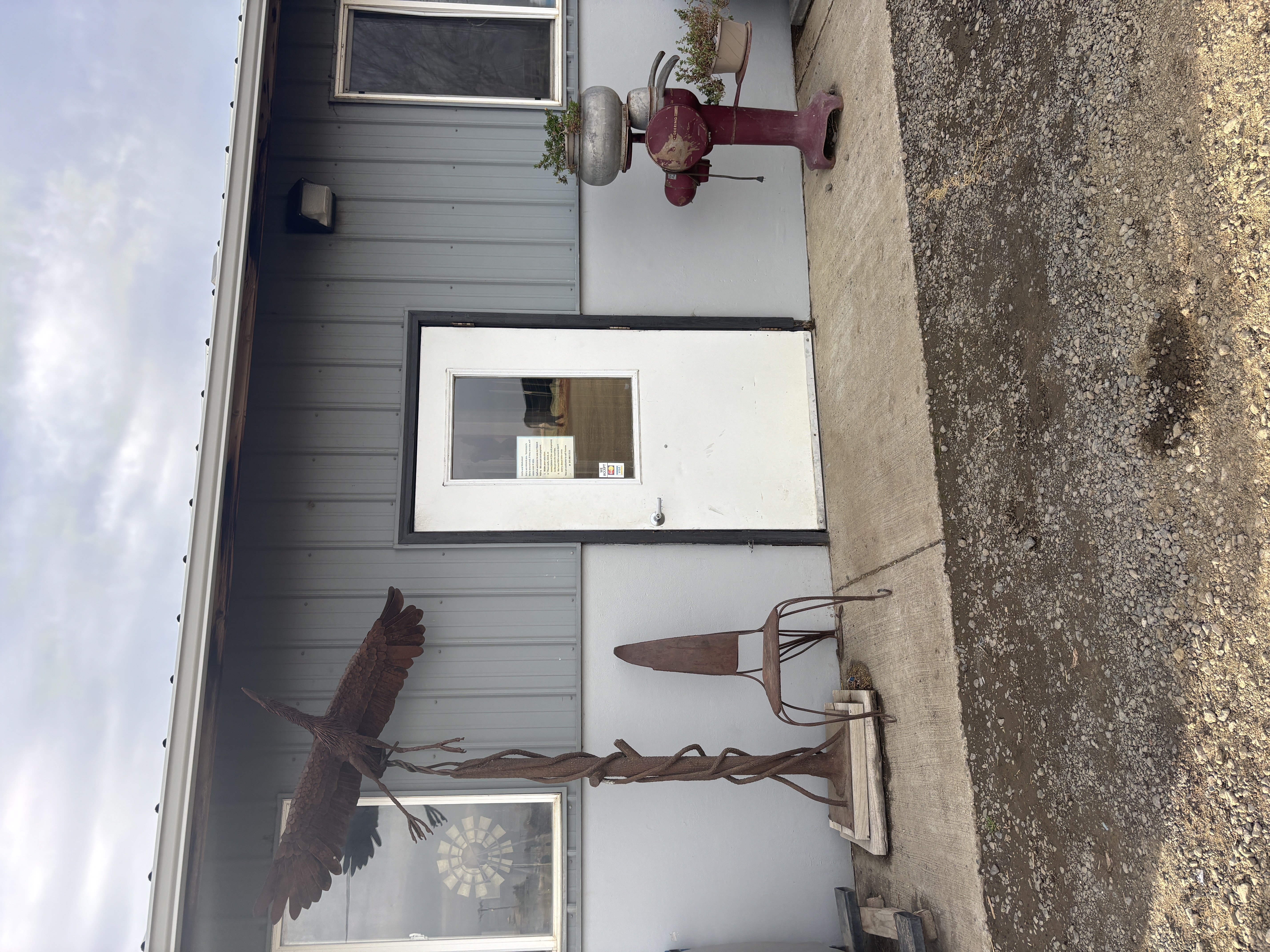 Entrance - gravel, sidewalk to large door