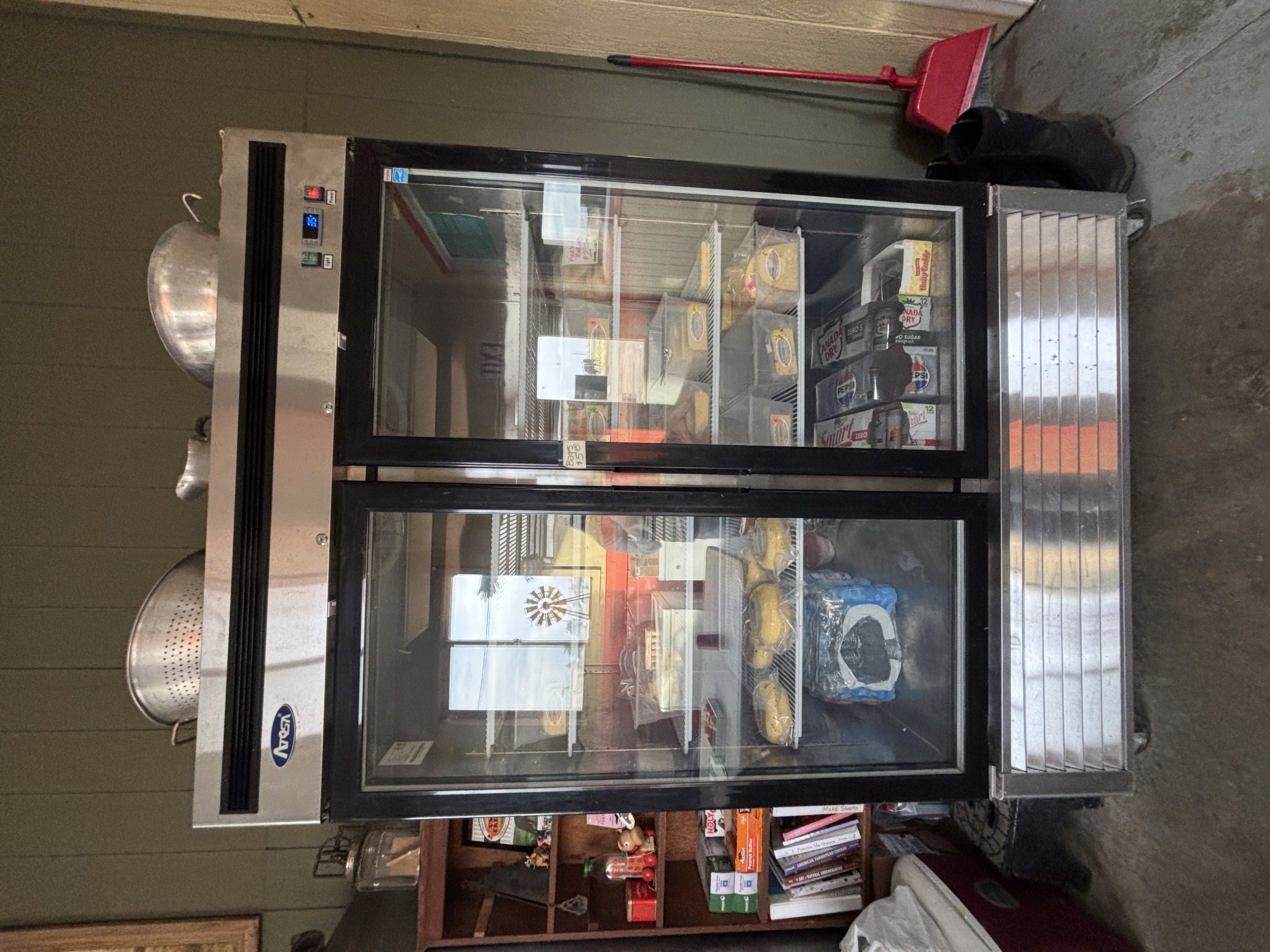 Two refrigerators - one with cheese products, the other with milk products.