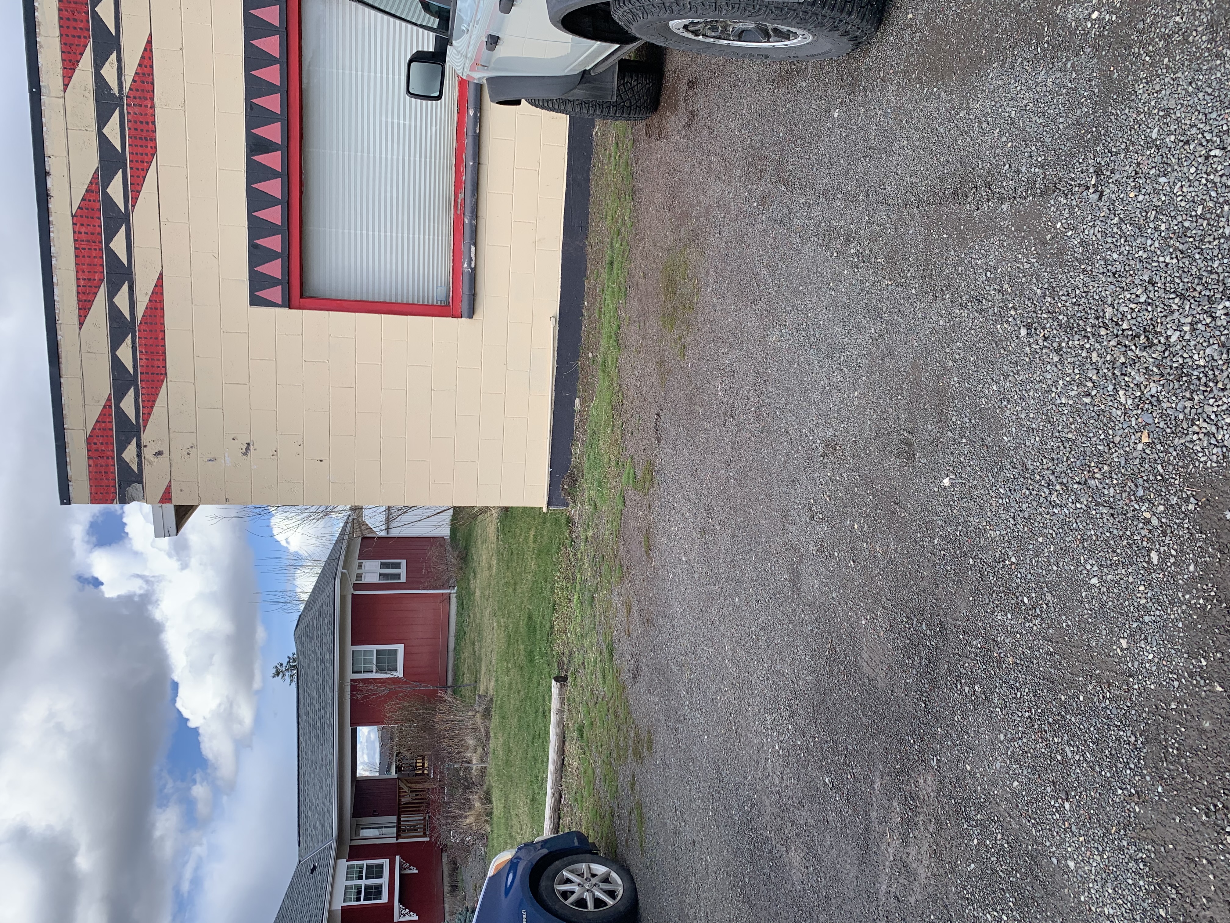 View of the gravel parking area from the road.