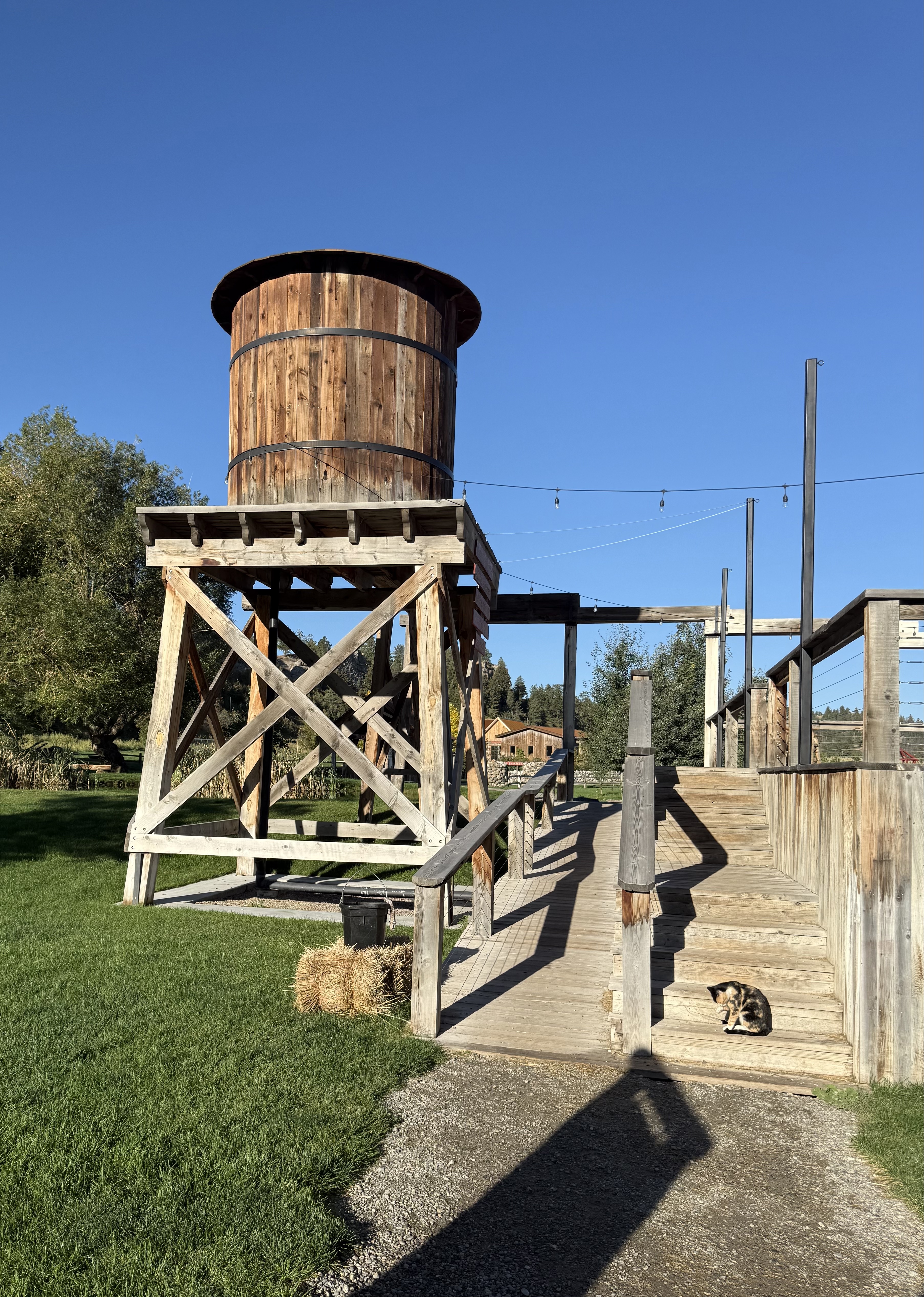 Large water tower with ramp and stairs to access the patio deck of the restaurant.