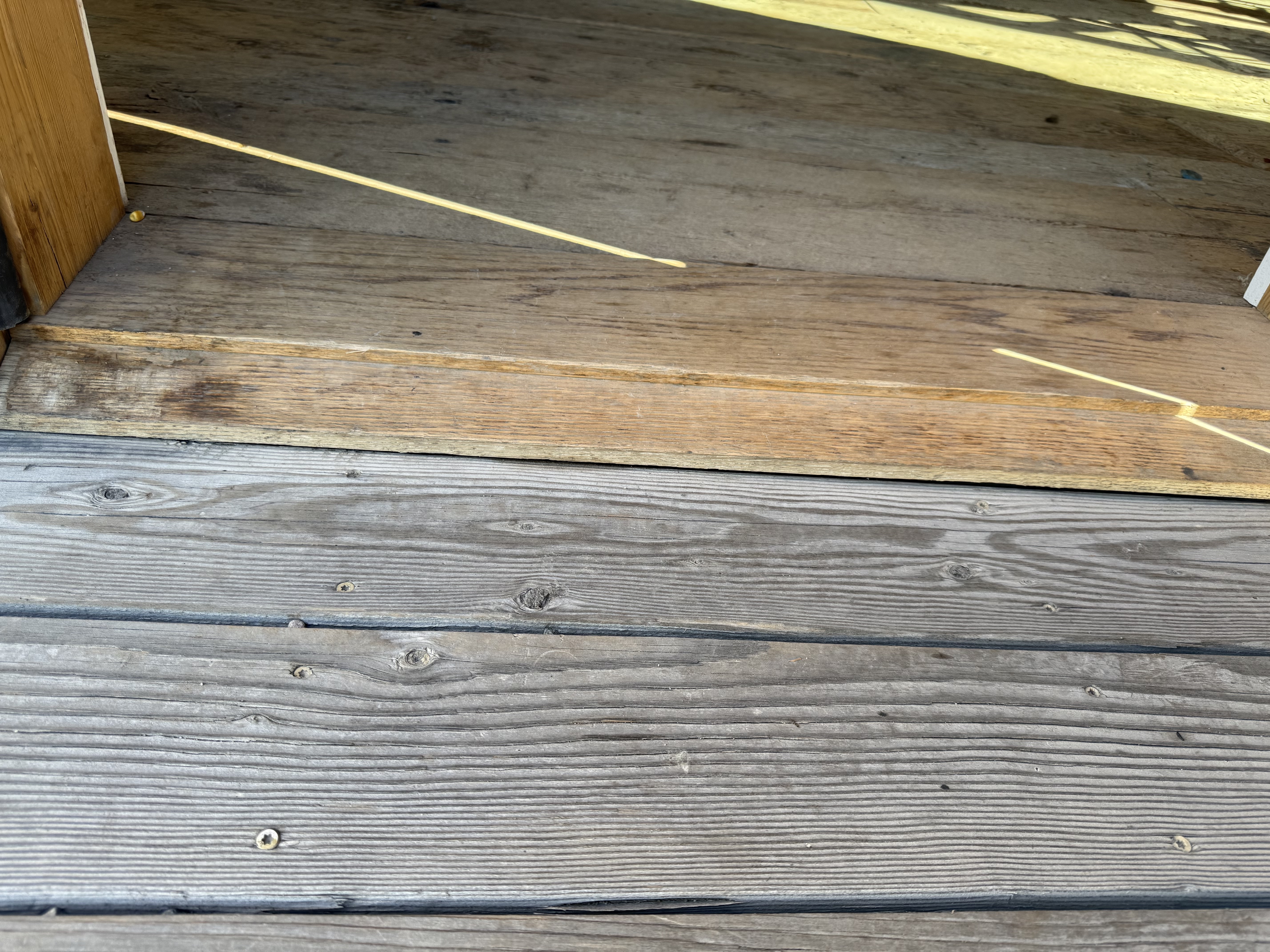 threshold made of two layers of wood, non-beveled and totaling close to half inch each.