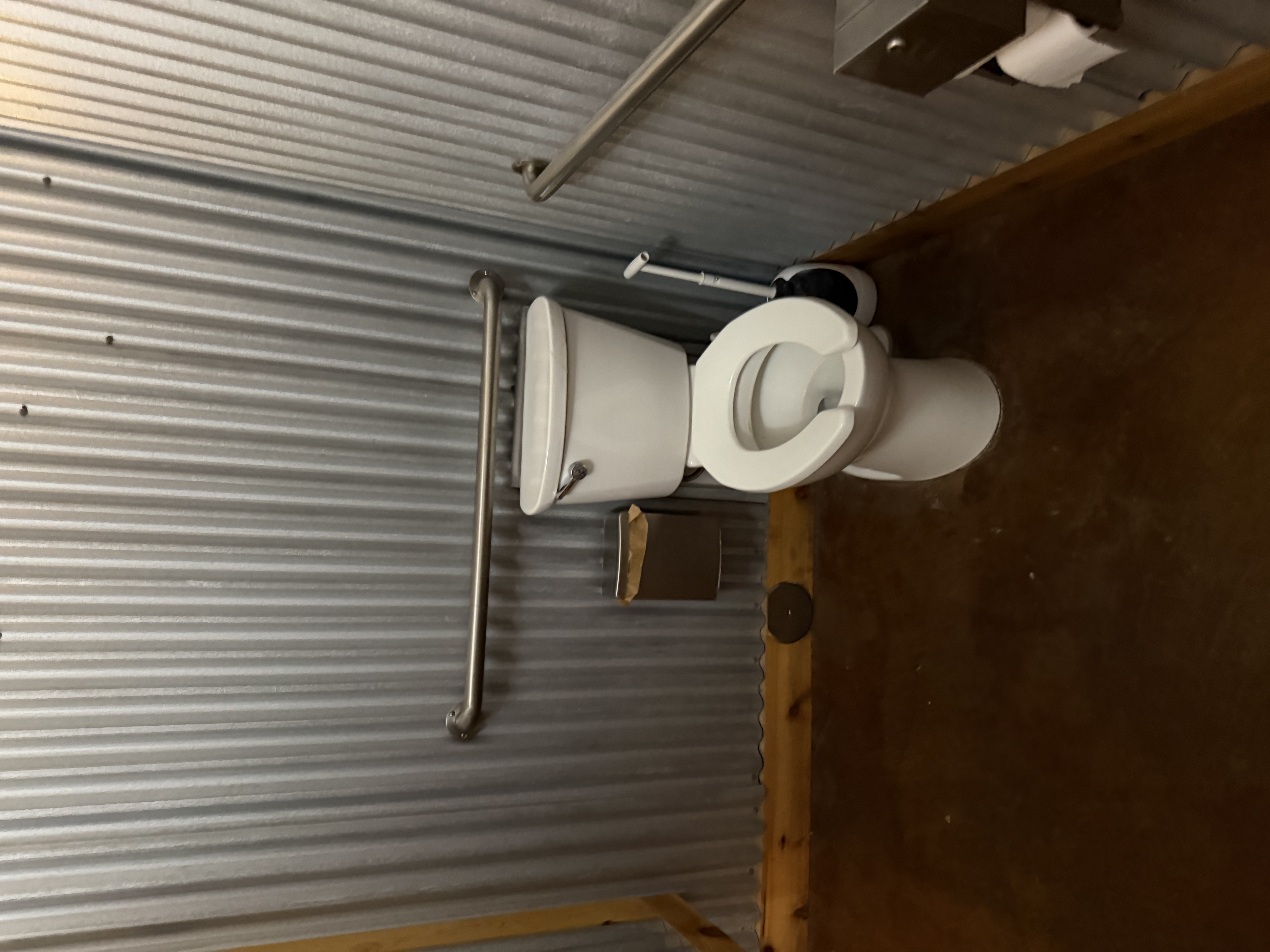 Womens restroom with transfer bars on right side of toilet