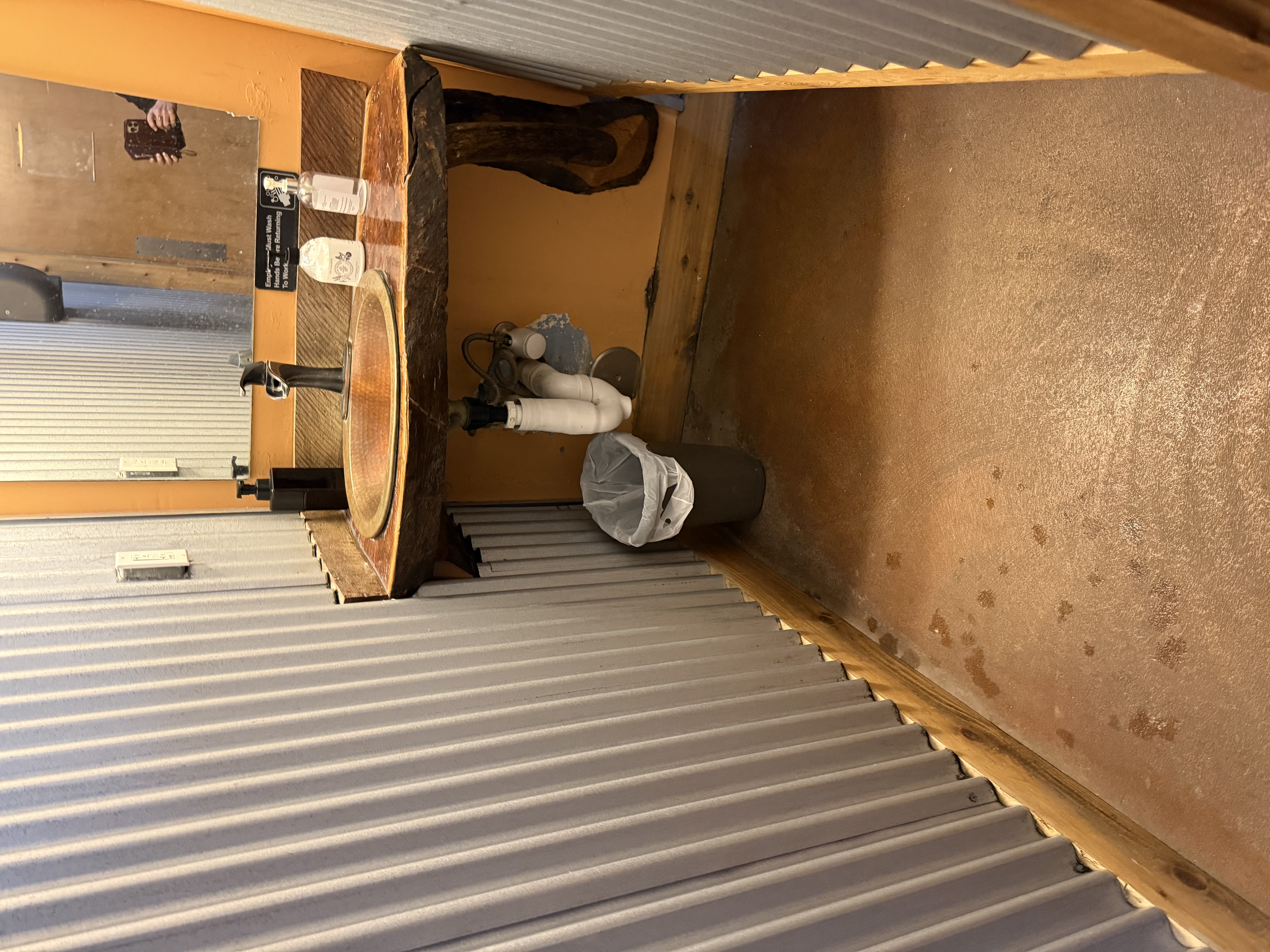 photo of the handwashing sink showing room to roll under counter with pipes wrapped