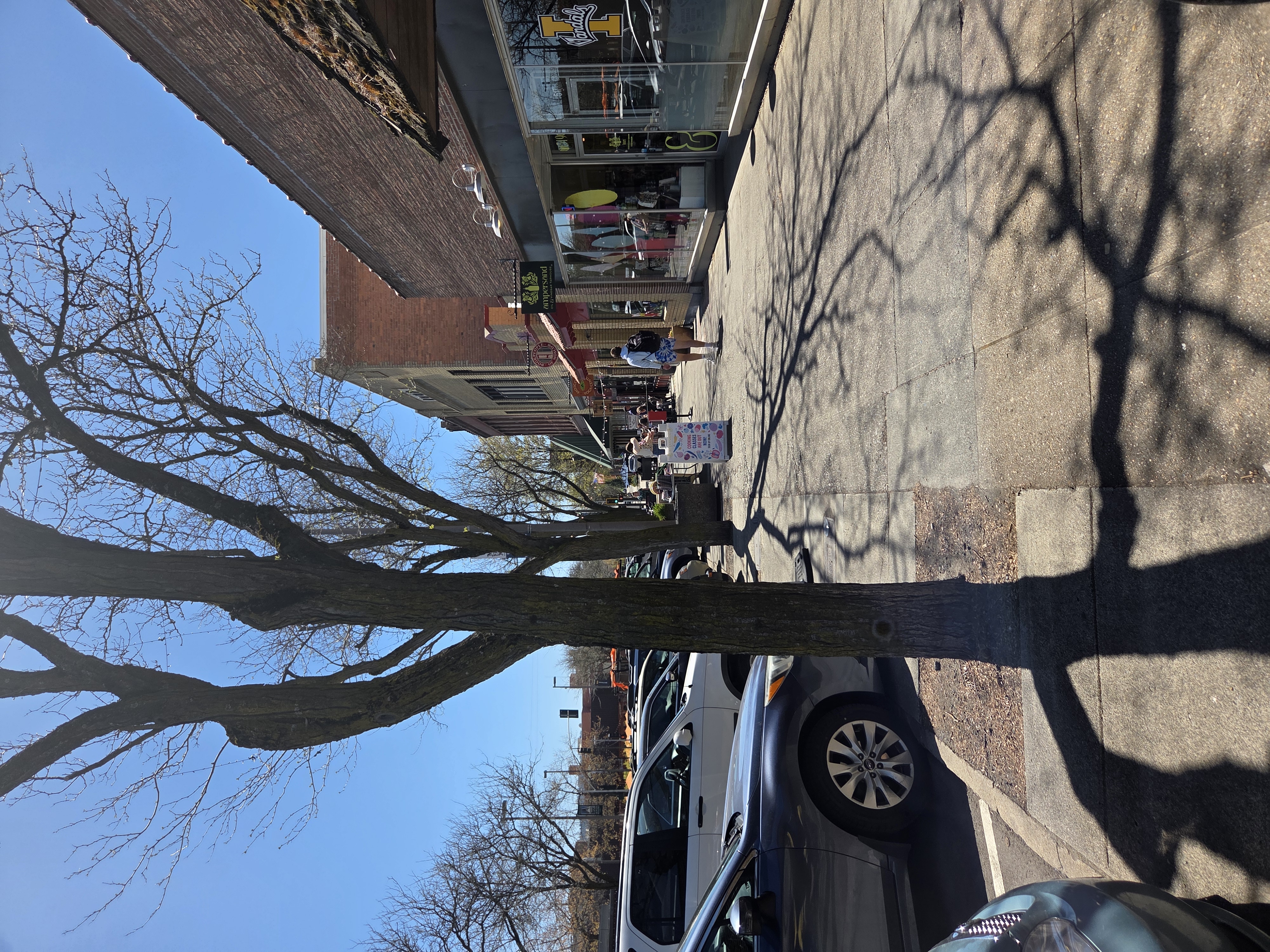 This photo is looking down Main Street towards Ampersand. It shows small and minimal signage and uneven pavement towards the front door.